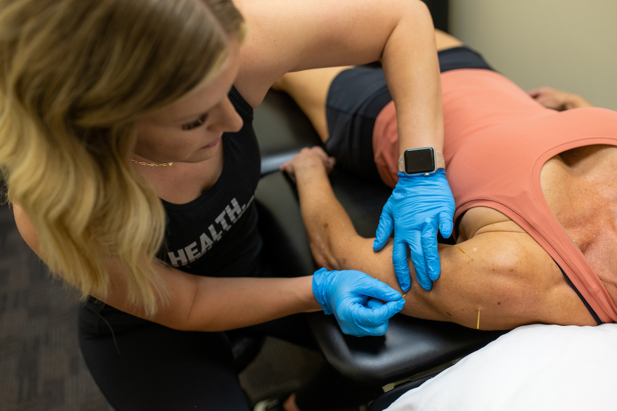 A woman is getting a massage from a massage therapist.